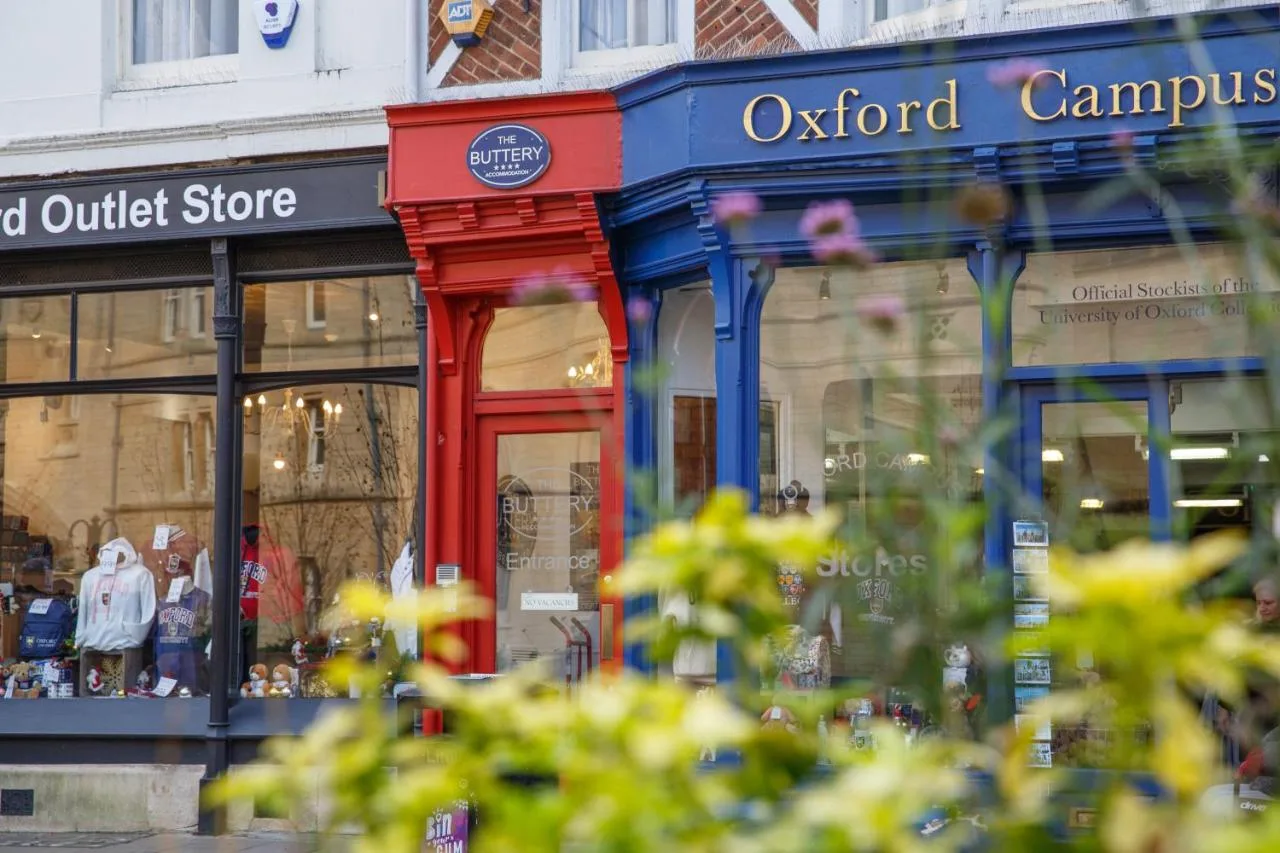 a store with a red door in a street at The Buttery in Oxford